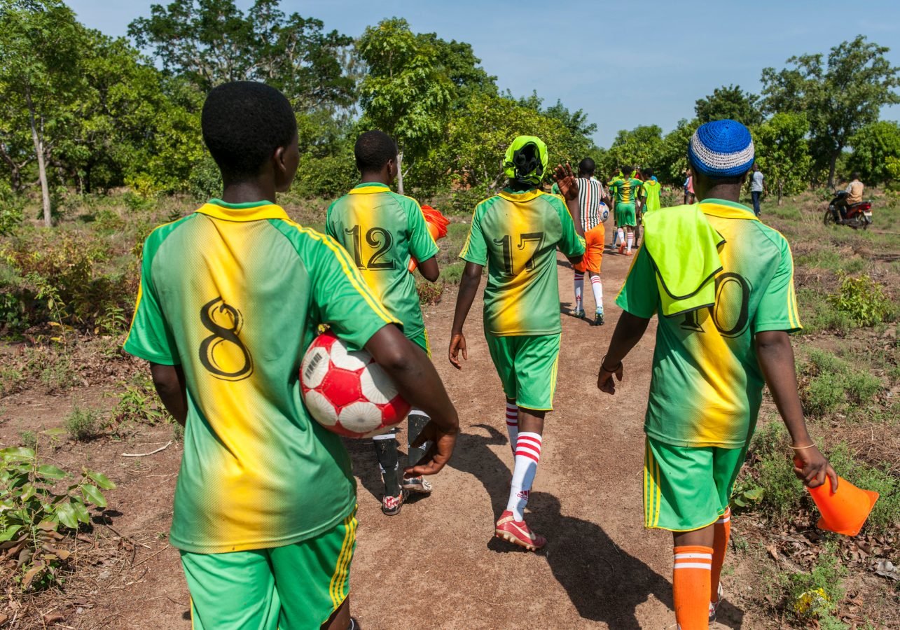 Girls' football team on their way home after training in Benin