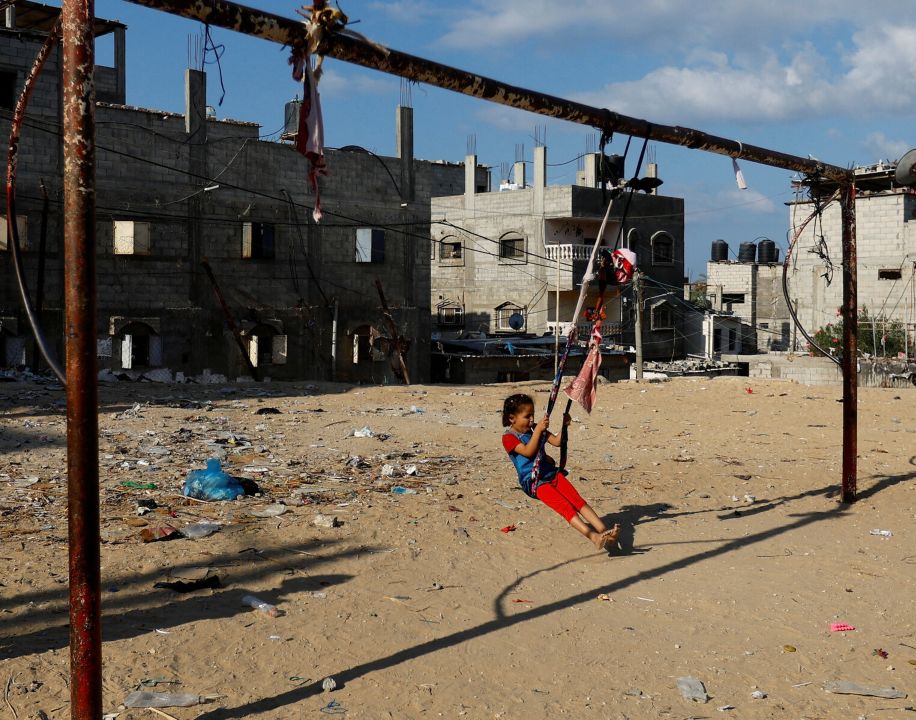 Girl playing on a swing in Gaza strip