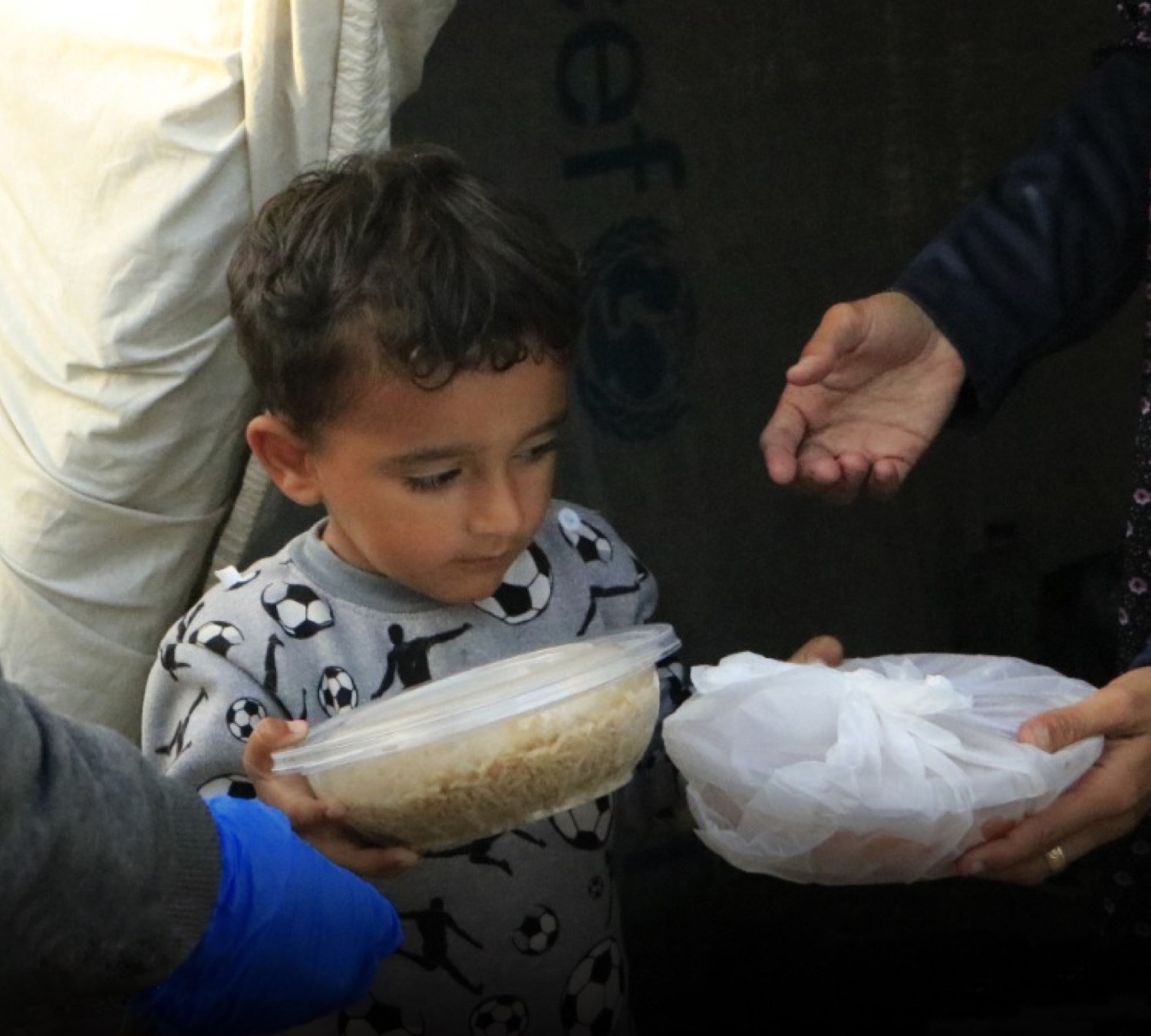 Young boy from Gaza getting food